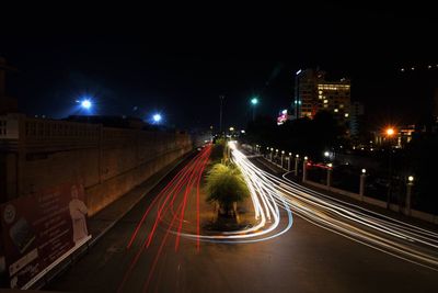 High angle view of light trails on road at night