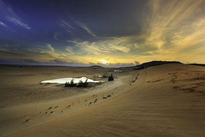 Scenic view of beach against sky during sunset