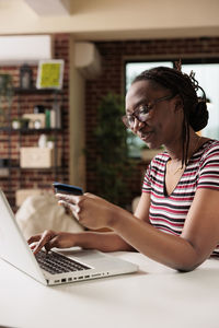 Young woman using laptop at home