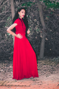 Portrait of young woman standing in forest
