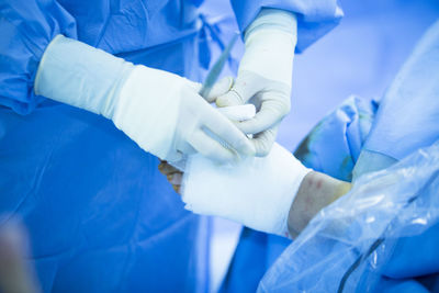 Midsection of surgeon operating patient at hospital