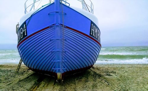 Blue fishing boat out of the sea