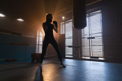 Rear view of silhouette woman standing on stage