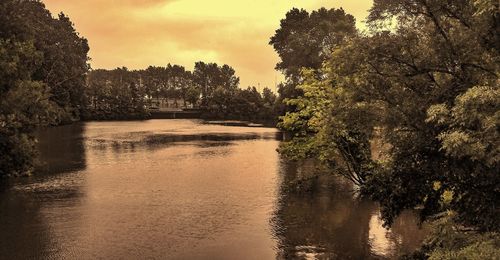 Scenic view of lake against sky at sunset