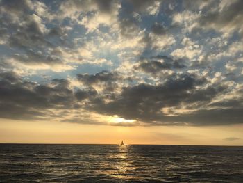 Scenic view of cloudscape over sea during sunset