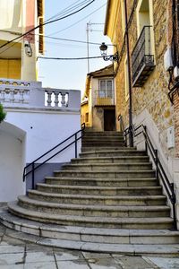 Low angle view of staircase by building against sky