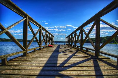 Bridge over sea against blue sky