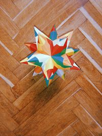 High angle view of multi colored umbrella on wooden table