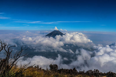 Panoramic view of volcanic mountain against blue sky