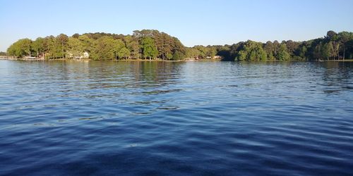 Scenic view of lake against clear blue sky