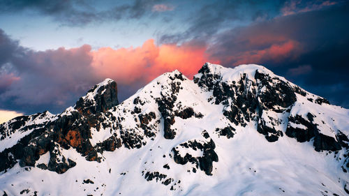 Scenic view of snow covered mountains against sky