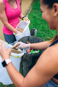 Female volunteers collecting garbage on field