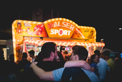 People in amusement park ride at night