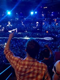 Rear view of people enjoying at music concert