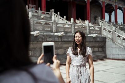 Portrait of woman photographing