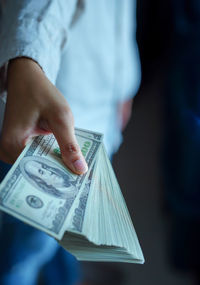 Midsection of person holding umbrella