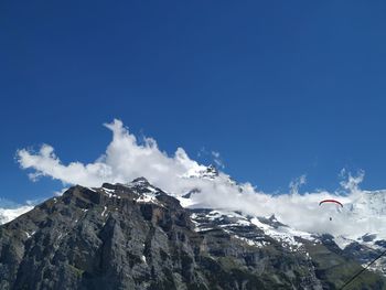 Scenic view of snowcapped mountains against blue sky