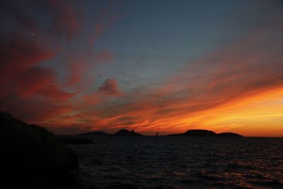 Scenic view of sea against orange sky