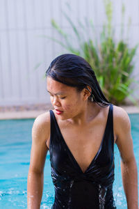 Close up view of sensuous asian woman standing in pool