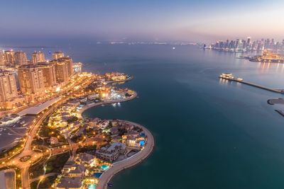 High angle view of city lit up at night