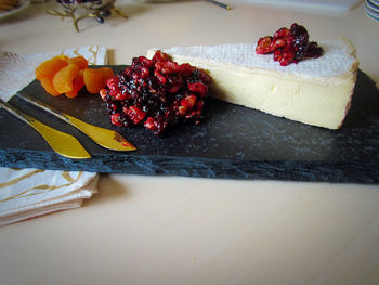 High angle view of brie with cranberry chutney on granite