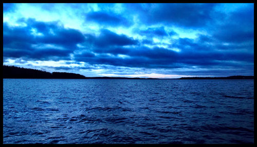 Scenic view of sea against cloudy sky