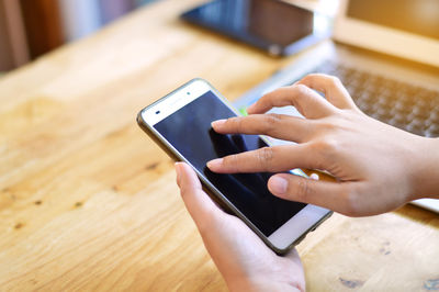 Midsection of man using mobile phone