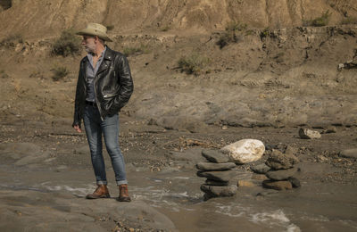 Adult man in cowboy hat in oasis of desert. almeria, spain