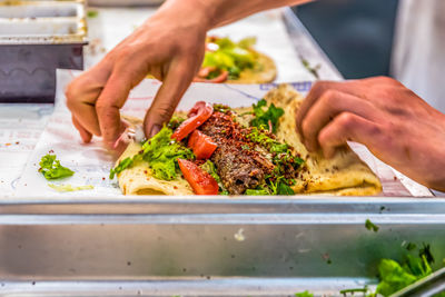 Midsection of person preparing food on tray