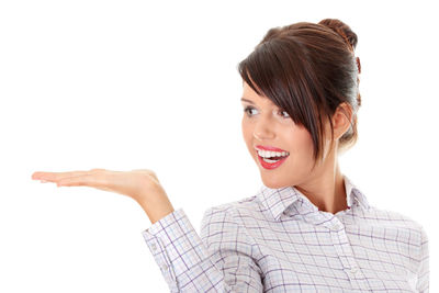 Portrait of a smiling young woman over white background