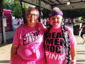 Portrait of smiling couple in pink at event