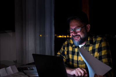 Man using mobile phone while sitting in office