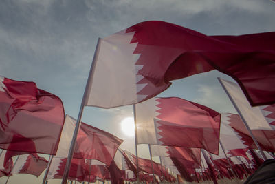 Low angle view of flag flags against sky