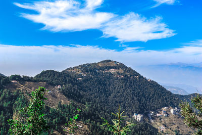 Scenic view of mountains against blue sky