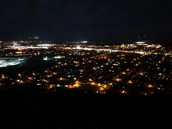 High angle view of illuminated buildings in city at night