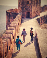 Rear view of people walking on walkway