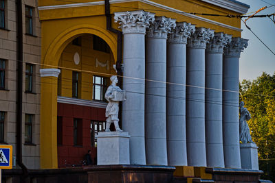 Low angle view of statue against historic building