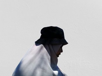 Side view of woman against white wall. - feeling like a shadow -