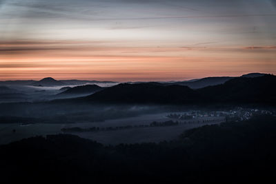 Scenic view of silhouette mountains against sky during sunset