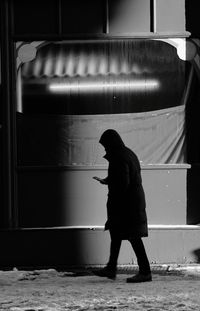 Rear view of man walking on wall