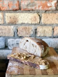 Close-up of bread on table against wall