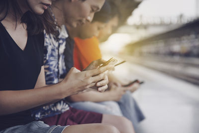 Midsection of woman using mobile phone
