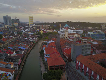 High angle view of town against sky at sunset