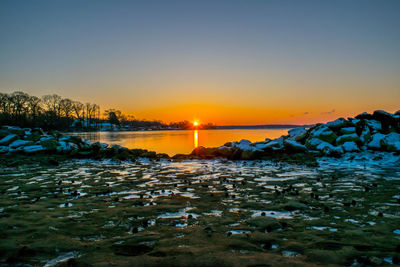 Scenic view of sea against sky at sunset