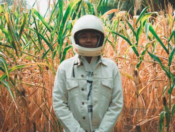 Portrait of teenage girl standing on field