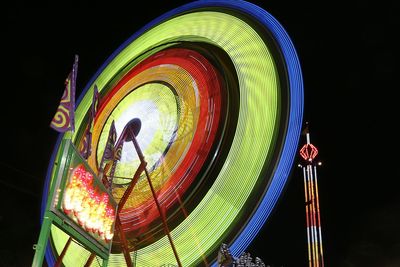 Low angle view of illuminated ferris wheel