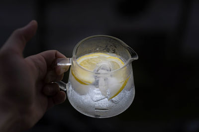 Close-up of hand holding glass of drink