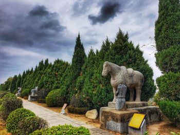 Statue in park against sky