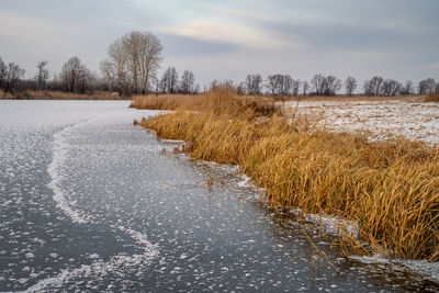 Scenic view of frozen lake against sky during winter