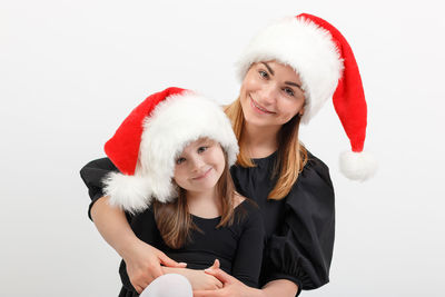 Portrait of a smiling young woman against white background